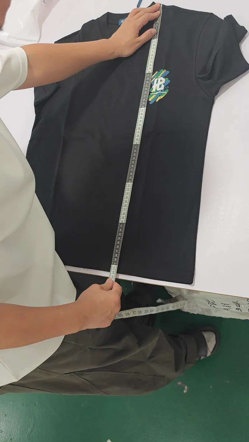 Measuring a T-shirt during a quality check